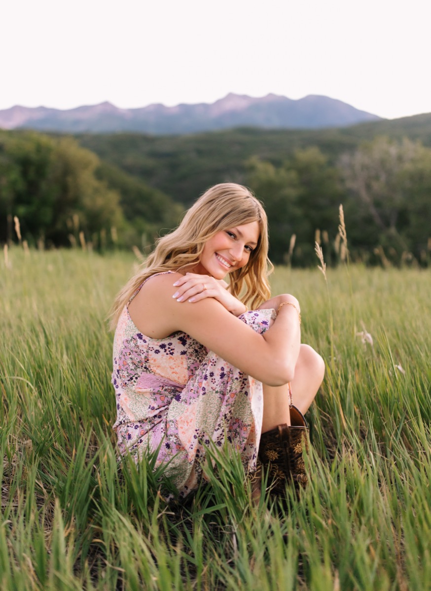 Harper sitting in the meadow