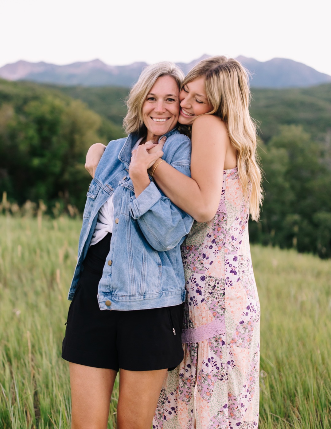 Niki and Harper hugging in a mountain meadow